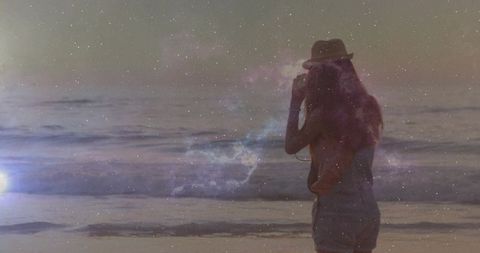 Woman Standing on Beach at Dusk with Nebula Overlay, Silhouette and Cosmic Starfield