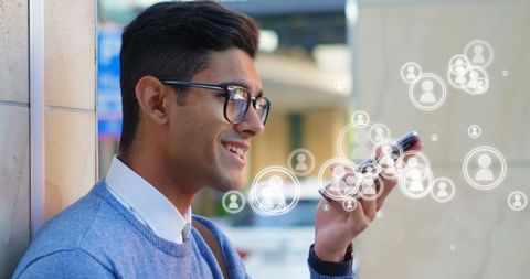 Young Man Interacting with Smartphone and Digital Icons