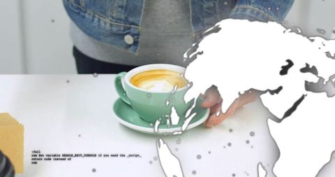 Placing mint cup and saucer with latte art on counter, denim jacket hand, world map overlay