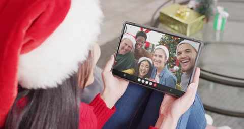 Woman Video Calling Friends During Christmas Using Tablet