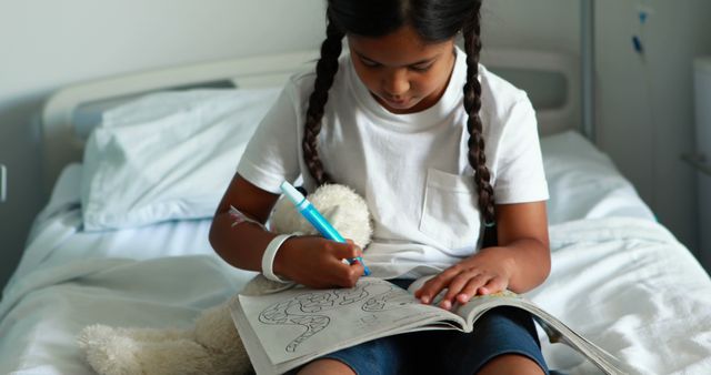 Girl with Pigtails Coloring in Hospital Bed - Download Free Stock Images Pikwizard.com