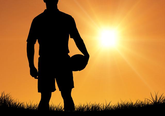 Digital composition of player silhouette holding rugby ball against sunset in background