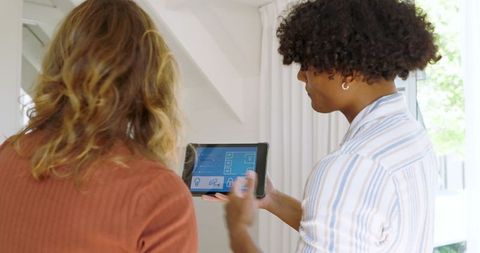 Couple Collaborating on Tablet Interface in Modern Living Room