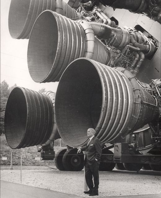 A pioneer of America's space program, Dr. von Braun stands by the five F-1 engines of the Saturn V launch vehicle. This Saturn V vehicle is an actual test vehicle which has been displayed at the U.S. Space Rocket Center in Huntsville, Alabama. Designed and developed by Rocketdyne under the direction of the Marshall Space Flight Center, a cluster of five F-1 engines was mounted on the Saturn V S-IC (first) stage. The engines measured 19-feet tall by 12.5-feet at the nozzle exit and burned 15 tons of liquid oxygen and kerosene each second to produce 7,500,000 pounds of thrust. The S-IC stage is the first stage, or booster, of a 364-foot long rocket that ultimately took astronauts to the Moon.