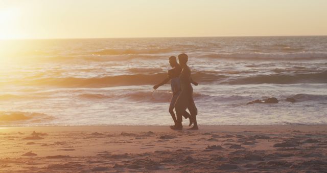 Couple Walking on Sunny Beach at Sunset - Download Free Stock Images Pikwizard.com