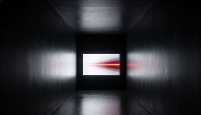 Minimalist Dark Corridor with Lit Screen Casting Red Light Streaks and Polished Reflections