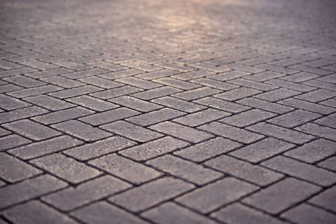 Close-up of herringbone pattern paving stone surface