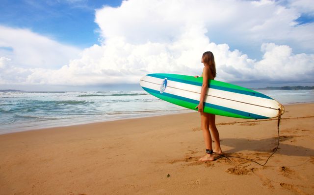 Woman Carrying Green Blue and White Surfboard during Daytime - Download Free Stock Photos Pikwizard.com