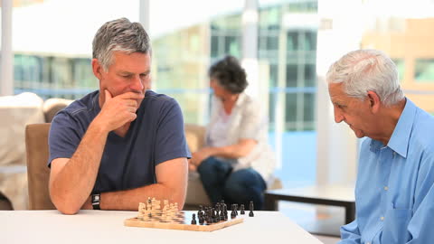 Senior Men Playing Intense Chess Game in Modern Setting
