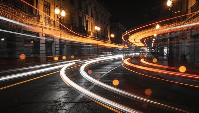 Long exposure light trails curving through wet historic city street at night with bokeh