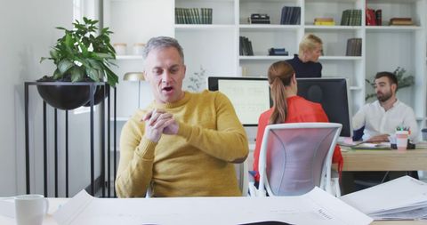 Business Team Discussing Plans in Modern Office Setting