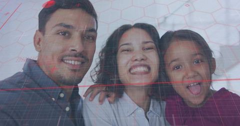 Smiling multicultural family posing for selfie with warm indoor light and red grid overlay