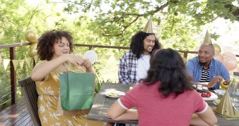 Multiracial Friends Celebrating Birthday on Sunny Terrace
