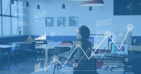 Businesswoman analyzing data on laptop in modern coworking lounge with holographic analytics overlay