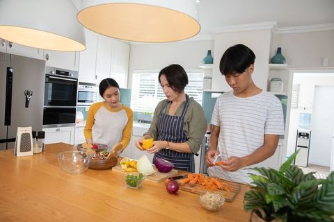 Family by Kitchen Island Learning to Cook Together