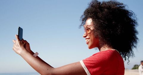 Happy Woman Taking Selfie on Sunny Beach