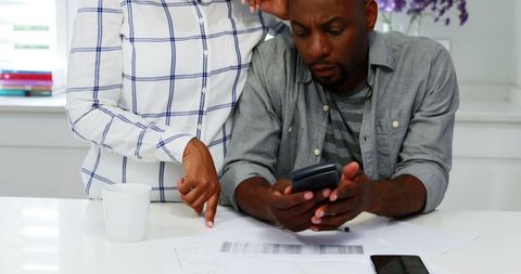 Colleagues collaborating over financial documents in office environment