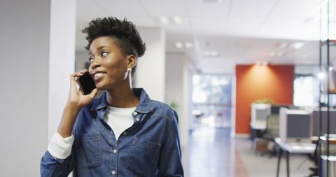 African American Businesswoman Talking on Smartphone in Modern Office