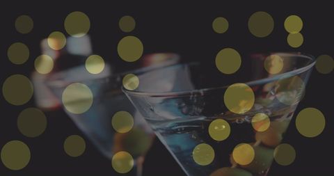 Festive martini party with glowing yellow bokeh lights