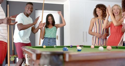 Lively Group Celebrating Pool Game Fun at Home