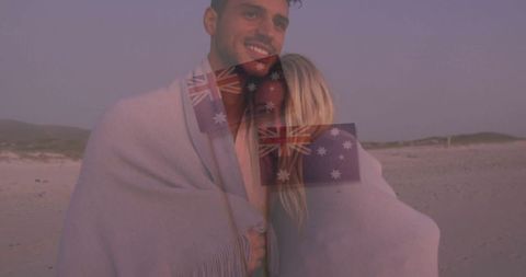 Couple Embracing on Beach at Dusk with Soft Blanket