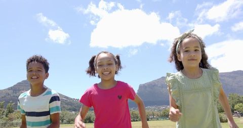 Joyful Children Running Outdoors on Sunny Day