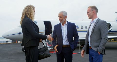 Corporate Professionals Shaking Hands at Private Jet Arrival - Download Free Stock Images Pikwizard.com