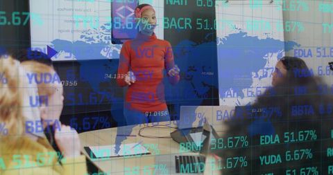 Presenter displaying financial analytics in modern boardroom meeting