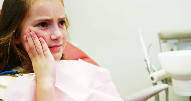 Young Girl Showing Dental Pain in Dentist Chair, Cheek Touching - Download Free Stock Images Pikwizard.com