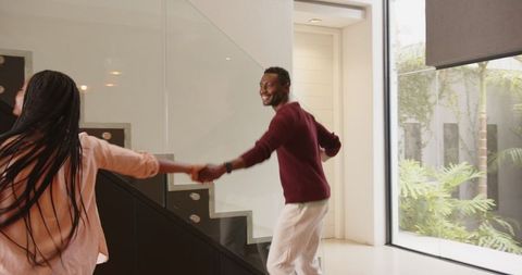 Playful Couple Dancing in Modern Foyer