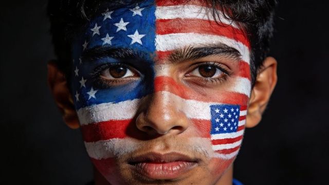 Young man showing american flag face paint close-up portrait portraying patriotic pride