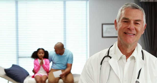 Smiling Doctor in Clinic with Young Girl and Her Father - Download Free Stock Images Pikwizard.com