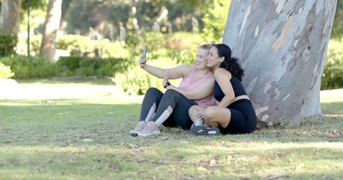 Diverse Female Friends Enjoying Selfie Moment in Sunny Park