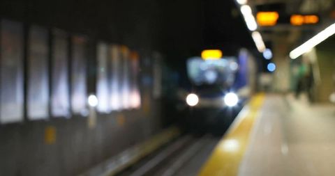 Approaching subway train with blurred platform focus