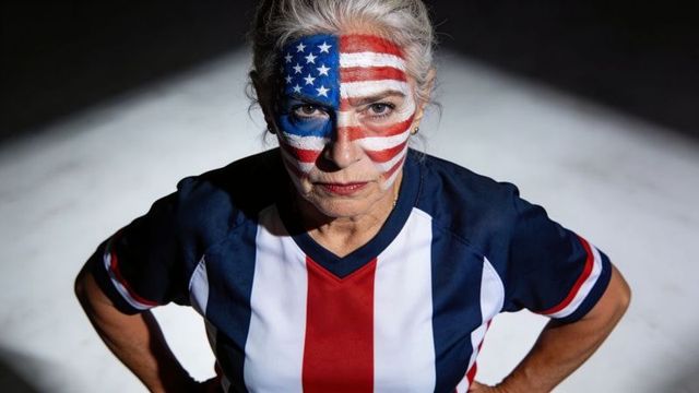 Senior woman wearing usa flag face paint in patriotic sports jersey, determined portrait