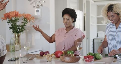 Friends Preparing Meal Together in Contemporary Kitchen Setting