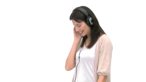 Smiling Woman Enjoying Music with Headphones on White Background