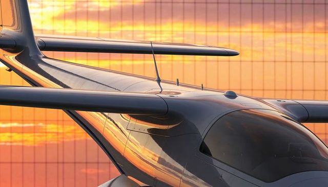 Sleek light aircraft fuselage reflecting golden-hour sunset on airport ramp