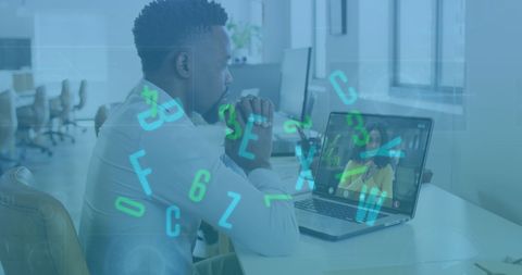 Business professional using laptop with digital interface elements