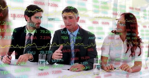 Business Team Analyzing Financial Charts Behind Glass Screen in Modern Boardroom