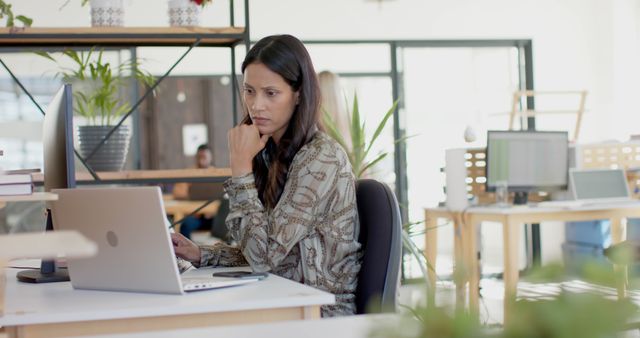 Woman Working on Laptop in Modern Office with Plants - Download Free Stock Images Pikwizard.com