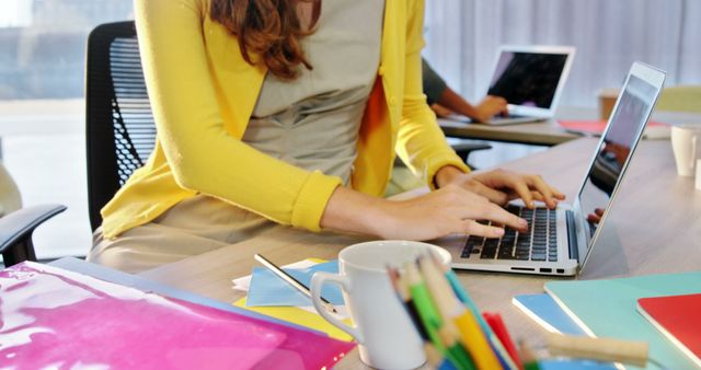 Young Professional Typing on Laptop in Bright Office Space - Download Free Stock Images Pikwizard.com