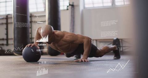 Performing one-handed medicine ball push-up showcasing core strength and functional power