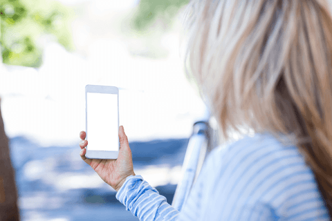 transparent smartphone screen held by woman in blue striped shirt - Download Free Stock Videos Pikwizard.com