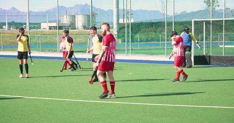 Field Hockey Players Competing on Artificial Turf