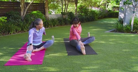 Asian Mother and Daughter Enjoying Outdoor Yoga Together