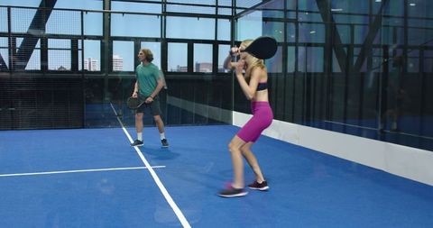 Young Athletes Playing Padel Tennis in Modern Indoor Court