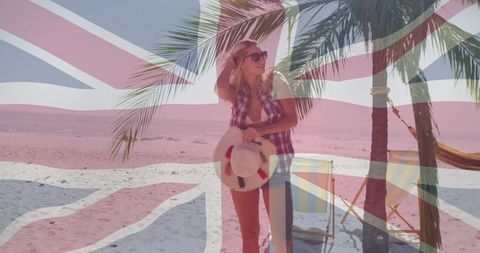 Fashionable Woman Standing on Tropical Beach with Union Jack Overlay