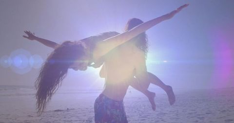 Couple Enjoying Playful Moment on Sunny Beach