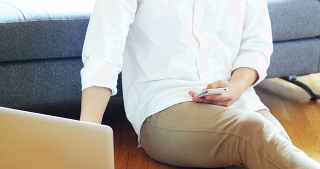 Young Man Using Laptop and Smartphone in Casual Home Setting - Download Free Stock Images Pikwizard.com